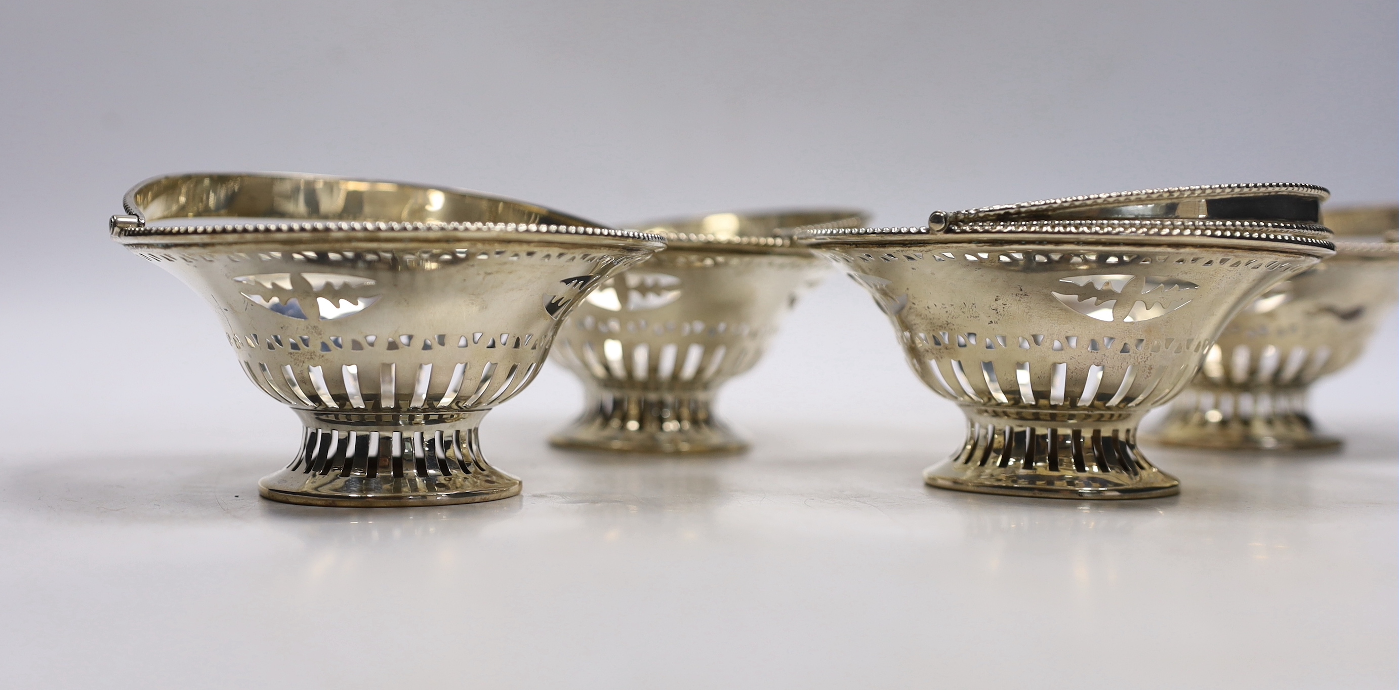 A set of four Edwardian pierced silver circular bonbon baskets, William Neale, Birmingham, 1908, 10cm.
